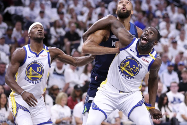 Golden State Warriors' Draymond Green and Jimmy Butler III vie for rebound position against Minnesota Timberwolves' Rudy Gobert in NBA Western Conference Semifinals' Game 5 at Target Center in Minneapolis on Wednesday, May 14, 2025. (Scott Strazzante/San Francisco Chronicle via AP)