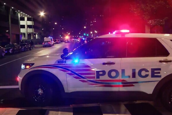 In this image taken from video provided by WJLA, law enforcement work the scene after two staff members of the Israeli embassy in Washington were shot and killed outside the Capital Jewish Museum on Wednesday, May 21, 2025, in Washington. (WJLA via AP)