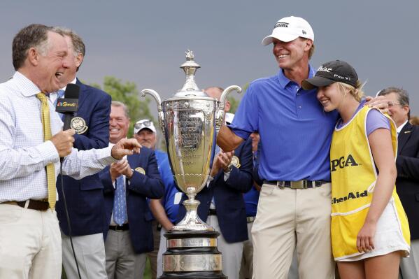 NBC's Jimmy Roberts, left, interviews Steve Stricker, of the United States, and his daughter and caddie, Izzi Stricker, after winning the Senior PGA Championship golf tournament at Fields Ranch East at PGA of America in Frisco, Texas, Sunday, May 28, 2023. (Elías Valverde II/The Dallas Morning News via AP)