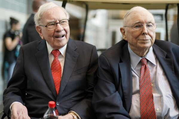 FILE- In this May 3, 2019 file photo, Berkshire Hathaway Chairman and CEO Warren Buffett, left, and Vice Chairman Charlie Munger, briefly chat with reporters before Berkshire Hathaway's annual shareholders meeting. Buffett credited his longtime partner 鈥� the late Charlie Munger 鈥� with being the architect of the Berkshire Hathaway conglomerate he鈥檚 received the credit for leading and warned shareholders in his annual letter not to listen to Wall Street pundits or financial advisors who urge them to trade often. (AP Photo/Nati Harnik, File)