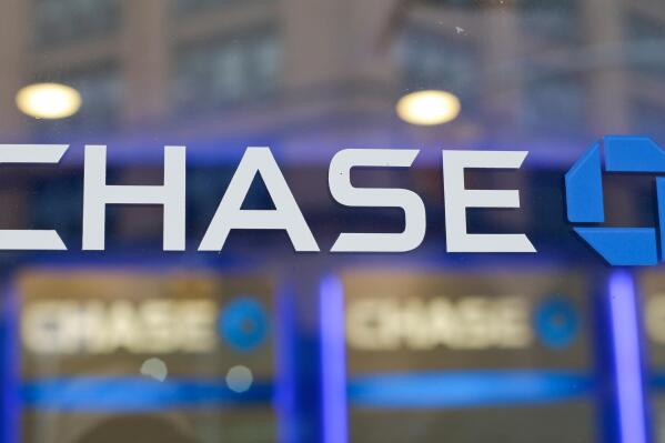 FILE - This Sept. 13, 2014, file photo, shows the Chase bank logo in New York. JPMorgan Chase says profits improved marginally in the third quarter, a notable change after the nation’s largest bank had to set aside billions in the last two quarters to cover losses from the coronavirus pandemic. The New York-based bank said it earned a profit of $9.44 billion, or $2.92 a share, in the July to September period.  (AP Photo/Frank Franklin II, File)