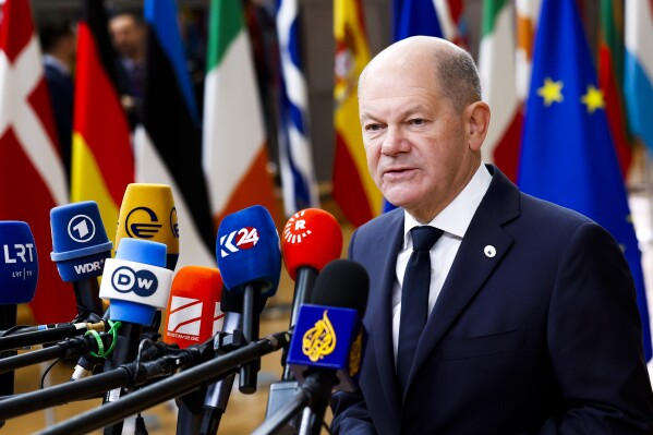 Germany's Chancellor Olaf Scholz talks to journalists as he arrives to an EU summit in Brussels, Thursday, Oct. 17, 2024. (AP Photo/Geert Vanden Wijngaert)