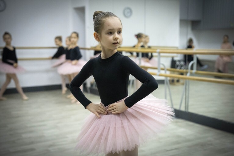 Girls practice in a ballet studio in a bomb shelter in Kharkiv, Ukraine, Monday, March 18, 2024. In northeast Ukraine, a dance studio that doubles as a bomb shelter is an escape from the horrors of war for about 20 young girls. The Princess Ballet Studio in Kharkiv is a spartan, windowless room, but practicing underground means they can dance through the almost hourly air raid alerts. (AP Photo/Efrem Lukatsky)