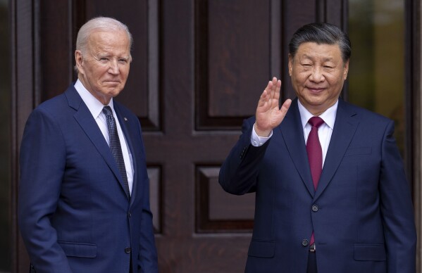 FILE - President Joe Biden, left, greets China's President President Xi Jinping in Woodside, Calif., Nov, 15, 2023. The United States sees Hong Kong's new national security law as a tool to potentially silence dissent both at home and abroad, but has tread carefully so far in responding, a disappointment to those fighting for democracy and freedoms in the Chinese territory. (Doug Mills/The New York Times via AP, Pool, File)
