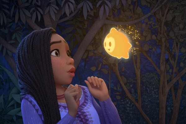 This image released by Disney shows Asha, voiced by Ariana DeBose, in a scene from the animated film "Wish." (Disney via AP)