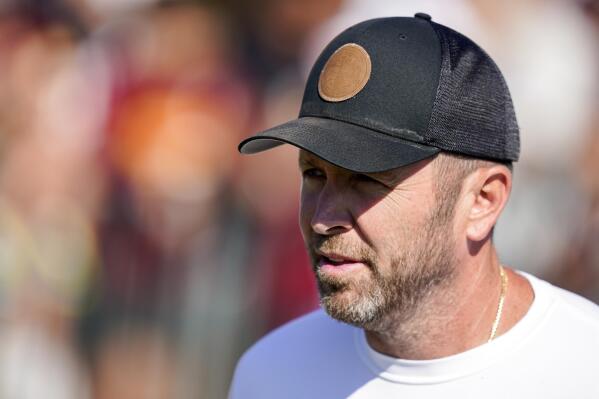 FILE -Washington Commanders offensive coordinator Scott Turner arrives for practice at the team's NFL football training facility, Thursday, Aug. 18, 2022, in Ashburn, Va. The Washington Commanders have fired offensive coordinator Scott Turner, according to a person with knowledge of the decision. The person spoke to The Associated Press on condition of anonymity Tuesday, Jan. 10, 2023 because the team had not announced the move.(AP Photo/Alex Brandon, File)