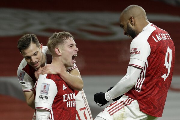 Arsenal's Emile Smith Rowe celebrates with Cedric Soares, left, and Alexandre Lacazette, right, a...