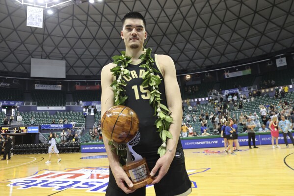 Purdue center Zach Edey (15) holds the MVP award after an NCAA college basketball game, Wednesday, Nov. 22, 2023, in Honolulu. (AP Photo/Marco Garcia)