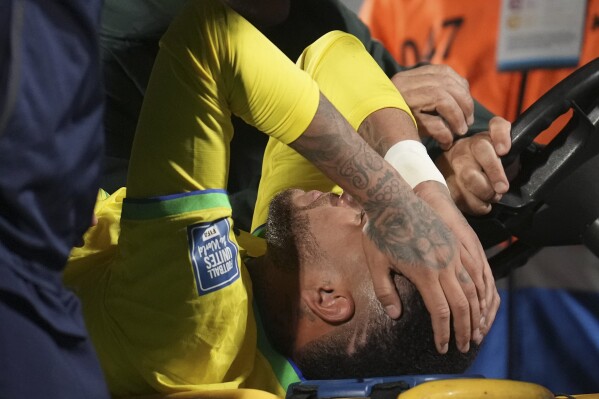 Brazil's Neymar is carried off the pitch on a stretcher after being injured during a qualifying soccer match for the FIFA World Cup 2026 against Uruguay at Centenario stadium in Montevideo, Uruguay, Tuesday, Oct. 17, 2023. (AP Photo/Matilde Campodonico)