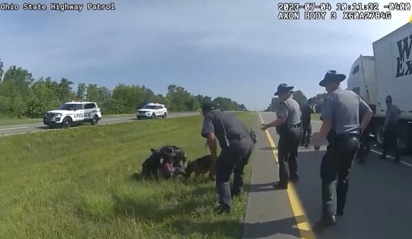 FILE - This image taken from police body cam video shows a police dog attacking Jadarrius Rose, 23, of Memphis, Tenn., on Tuesday, July 4, 2023, in Circleville, Ohio. An Ohio police department has fired an officer who released his police dog on a surrendering truck driver even after state troopers told him to hold the dog back. A statement issued Wednesday, July 26, 2023, by Circleville police said Ryan Speakman “did not meet the standards and expectations we hold for our police officers” and that he has been “terminated from the department, effective immediately.” (Ohio State Highway Patrol via AP, File).