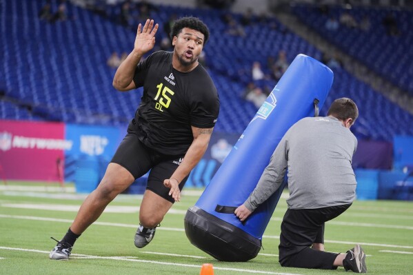 Oregon defensive lineman Derrick Harmon runs a drill at the NFL football scouting combine in Indianapolis, Thursday, Feb. 27, 2025. (AP Photo/Michael Conroy, File)