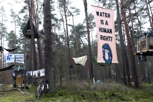 Activists occupy an area in the forest in Groenheide, Germany, Friday March 1, 2024. Environmental activists are staging a protest in a forest near Berlin against plans to expand the grounds of electric car maker Tesla’s first plant in Europe and are vowing to stay in place for weeks. About 100 activists have been occupying part of the forest since early Thursday, according to an initiative called “Stop Tesla.” (Cevin Dettlaff/dpa via AP)