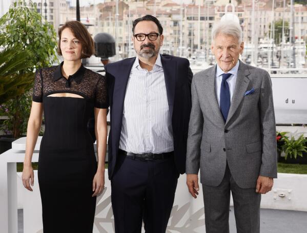 Phoebe Waller-Bridge, from left, director James Mangold, and Harrison Ford pose for photographers at the photo call for the film 'Indiana Jones and the Dial of Destiny' at the 76th international film festival, Cannes, southern France, Friday, May 19, 2023. (Photo by Joel C Ryan/Invision/AP)