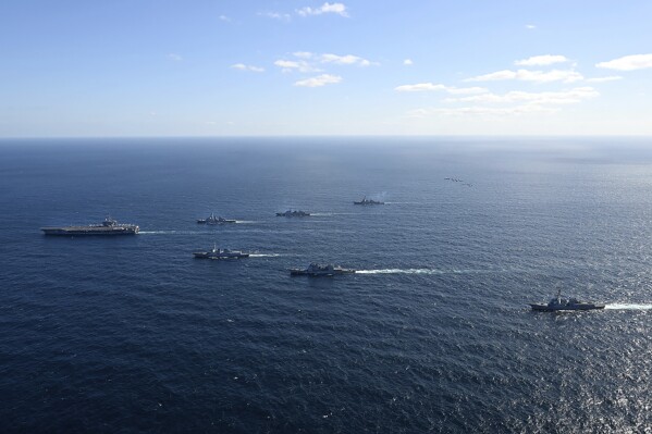 In this photo provided by South Korea's Joint Chiefs of Staff, the aircraft carrier USS Carl Vinson, left, sails with South Korea and Japan's destroyers in the international waters of the southern coast of Korean peninsular during a recent joint drill in 2024. The three countries conducted combined naval exercises involving the American aircraft carrier in their latest show of strength against nuclear-armed North Korea, South Korea’s military said Wednesday, Jan. 17, as the three countries' senior diplomats were to meet in Seoul to discuss the deepening standoff with Pyongyang. (South Korea's Joint Chiefs of Staff via AP)