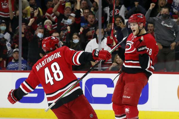 Carolina Hurricanes' Steven Lorentz (78) celebrates his goal with teammate Jordan Martinook (48) during the second period of an NHL hockey game against the Toronto Maple Leafs in Raleigh, N.C., Monday, Oct. 25, 2021. (AP Photo/Karl B DeBlaker)