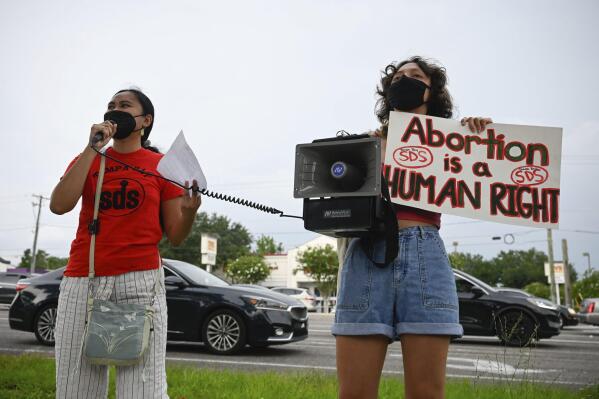Chrisley Carpio and Victoria Hinckley, 20 speak to protesters during an abortion rights rally on Saturday, June 25, 2022 in Temple Terrace, Fla.  A Florida judge on Thursday, June 30,  said he would temporarily block a 15-week abortion ban from taking effect, following a court challenge by reproductive health providers who say the state constitution guarantees a right to the procedure. (Jefferee Woo/Tampa Bay Times via AP)