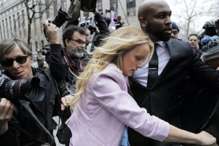 
              Stormy Daniels arrives at federal court in New York, Monday, April 16, 2018, to attend a court hearing where a federal judge is considering how to review materials that the FBI seized from President Donald Trump's personal lawyer to determine whether they should be protected by attorney-client privilege.(AP Photo/Seth Wenig)
            
