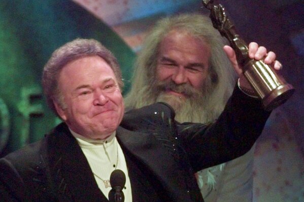 
              FILE- In this April 23, 1997, file photo, musician Roy Clark celebrates after receiving the Pioneer Award at the Academy of Country Music Awards in Universal City, Calif. Clark, the guitar virtuoso and singer who headlined the cornpone TV show "Hee Haw" for nearly a quarter century, died Thursday, Nov. 15, 2018, due to complications from pneumonia at home in Tulsa, Okla., publicist Jeremy Westby said. He was 85.   (AP Photo/Reed Saxon, File)
            
