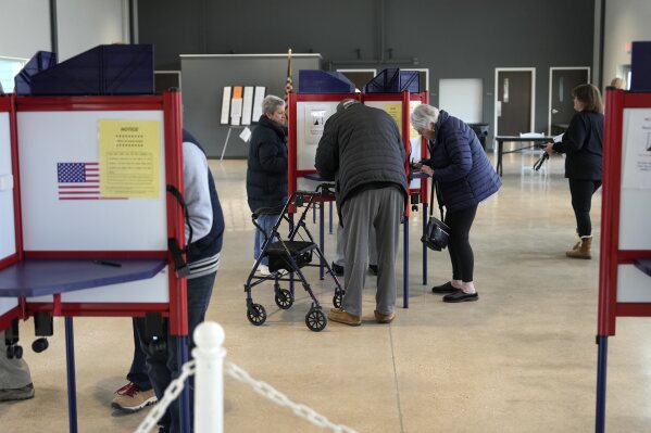 Voters mark their ballots while voting at Waters Edge event venue in the state&#x27;s Supreme Court election, Tuesday, April 1, 2025, in Milwaukee. (AP Photo/Kayla Wolf)