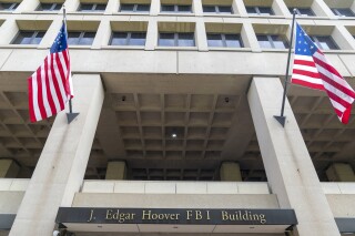 FILE - The J. Edgar Hoover FBI Building is seen June 9, 2023, in Washington. The Justice Department is ramping up its efforts to reduce violent crime in the U.S., launching a specialized gun intelligence center in Chicago and expanding task forces to curb carjackings. (AP Photo/Alex Brandon, File)