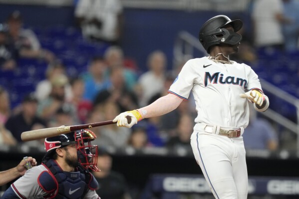 Miami Marlins' Jazz Chisholm Jr. watches after hitting a grand slam during the third inning of a baseball game against the Atlanta Braves, Sunday, Sept. 17, 2023, in Miami. (AP Photo/Lynne Sladky)