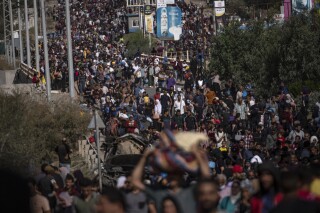 Palestinians flee to the southern Gaza Strip on Salah al-Din Street in Bureij, Gaza Strip, Friday, Nov. 10, 2023. (AP Photo/Fatima Shbair)