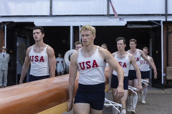 This image released by MGM Pictures shows Callum Turner, center, in a scene from "The Boys in the Boat." (Laurie Sparham/Metro-Goldwyn-Mayer Pictures via AP)