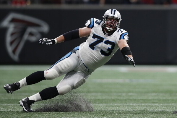 FILE - Carolina Panthers offensive guard Greg Van Roten slides while trying to tackle Atlanta Falcons cornerback Ricardo Allen after an interception during an NFL football game Sept. 16, 2018, in Atlanta. When Aaron Rodgers went down with an injury just a few plays into his first season with the New York Jets, it reignited calls from NFL players to have all the stadiums in which they play use natural grass fields for their safety. In major college football, the players don’t have a union behind them to voice concerns. (AP Photo/Jeff Haynes, File)