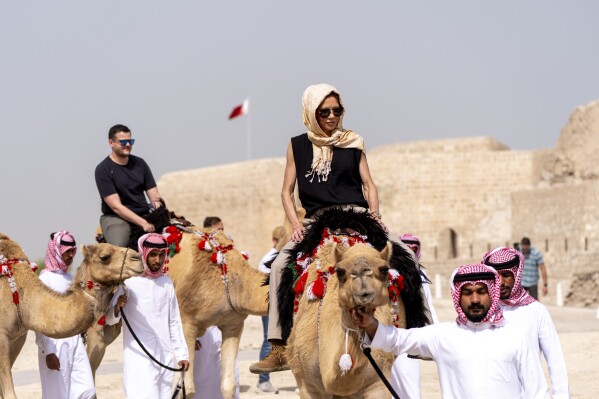 Homeland Security Secretary Kristi Noem rides a camel after a tour of Qal'at al-Bahrain Fort, Sunday, May 25, 2025, near Manama, Bahrain. (AP Photo/Alex Brandon, Pool)