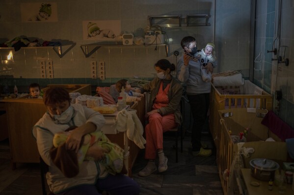 Hospital staff take care of orphaned children at the children's regional hospital maternity ward in Kherson, southern Ukraine, Tuesday, Nov. 22, 2022. (AP Photo/Bernat Armangue)