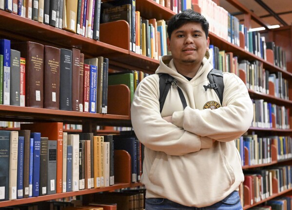 Jesus Noyola, a sophomore attending Rensselaer Polytechnic Institute, poses for a portrait in the Folsom Library, Tuesday, Feb. 13, 2024, in Troy, N.Y. A later-than-expected rollout of a revised Free Application for Federal Student Aid, or FASFA, that schools use to compute financial aid, is resulting in students and their parents putting off college decisions. Noyola said he hasn’t been able to submit his FAFSA because of an error in the parent portion of the application. “It’s disappointing and so stressful since all these issues are taking forever to be resolved,” said Noyola, who receives grants and work-study to fund his education. (AP Photo/Hans Pennink)