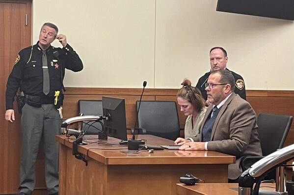 Rebecca Auborn, accused of killing four men by fatally drugging them to steal their possessions, sits in a Franklin County courtroom in Columbus, Ohio alongside her attorney, Mark Hunt on Monday, Oct. 30, 2023. Auborn pled not guilty to the deaths of the four men and a near fatal overdose of another, but investigators believe she has more alleged victims. (AP Photo/Samantha Hendrickson)