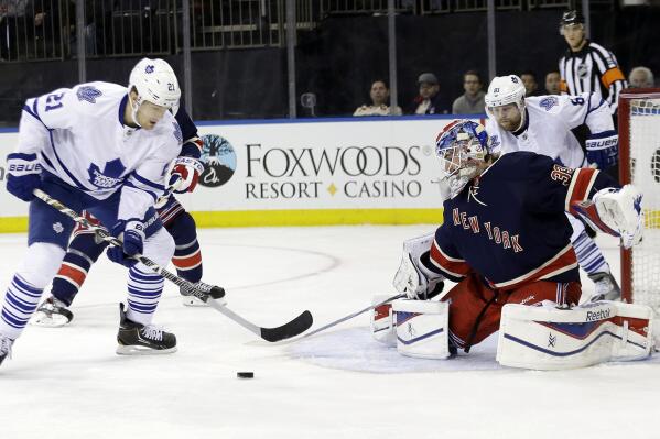 New York Rangers goalie Cam Talbot (33) stops a shot on the goal by Toronto Maple Leafs' James van Riemsdyk (21) during the first period of an NHL hockey game, Monday, Dec. 23, 2013, in New York. (AP Photo/Frank Franklin II)