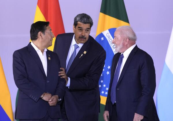 Bolivia's President Luis Arce, from left, Venezuela's President Nicolas Maduro and Brazilian President Luiz Inacio Lula da Silva assemble for a group photo during the South American Summit at Itamaraty palace in Brasilia, Brazil, Tuesday, May 30, 2023. South America's leaders are gathering as part of Lula's attempt to reinvigorate regional integration efforts. (AP Photo/Andre Penner)