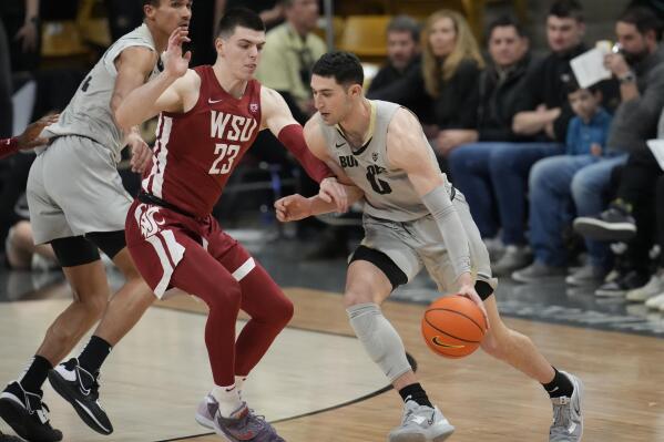 Colorado guard Luke O'Brien, right, drives to the rim as Washington State forward Andrej Jakimovski defends in the first half of an NCAA basketball game, Sunday, Jan. 22, 2023, in Boulder, Colo. (AP Photo/David Zalubowski)