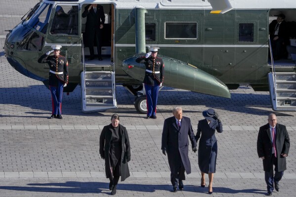 First lady Melania Trump, from second right, and President Donald Trump walk as former President Joe Biden salutes after boarding a Marine helicopter en route to Joint Base Andrews after the 60th Presidential Inauguration, Monday, Jan. 20, 2025, at the U.S. Capitol in Washington. (Jack Gruber/Pool Photo via AP)
