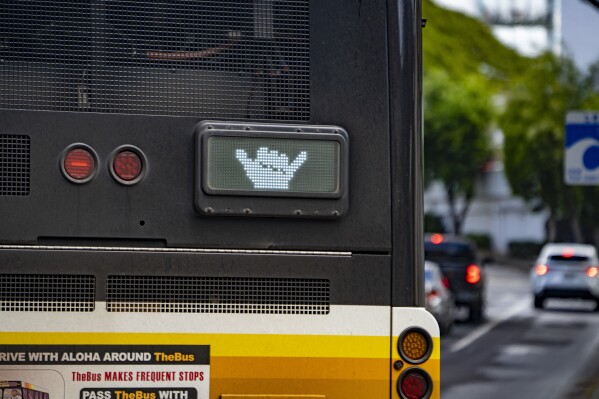 A Honolulu City Bus, TheBus, displays a shaka after merging to Alapai Street on Wednesday, March 6, 2024, in Honolulu, Hawaii. (AP Photo/Mengshin Lin)
