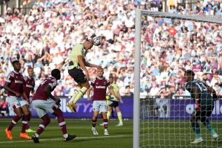 Manchester City's Erling Haaland heads the ball during the English Premier League soccer match between West Ham United and Manchester City at the London Stadium in London, England, Sunday, Aug. 7, 2022. (AP Photo/Frank Augstein)