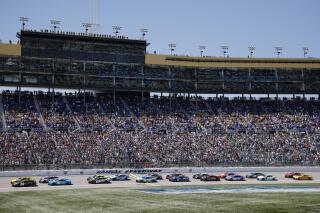 Drivers head down the front straightaway at the start of a NASCAR Cup Series auto race at Kansas Speedway in Kansas City, Kan., Sunday, May 7, 2023. (AP Photo/Colin E. Braley)