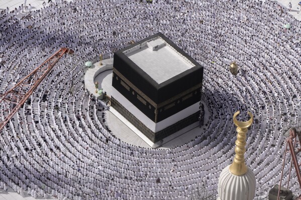 FILE - Muslim pilgrims pray around the Kaaba, the cubic building at the Grand Mosque, during the annual Hajj pilgrimage in Mecca, Saudi Arabia, Sunday, June 25, 2023. In the Middle East and North Africa, where religion is often ingrained in daily life's very fabric, rejecting faith can come with social or other repercussions, so many of the "nones," a group that includes agnostics, atheists and "nothing in particular" conceal that part of themselves, as blasphemy laws and policies are widespread in the region. (AP Photo/Amr Nabil, File)