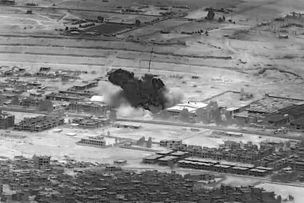 This image from video provided by the Department of Defense shows a Nov. 8, 2023, airstrike on a weapons warehouse. center, in eastern Syria. The strike targeted a facility linked to Iranian-backed militias, in retaliation for what has been a growing number of attacks on bases housing U.S. troops in the region for the past several weeks. Iranian-backed militants in Iraq and Syria have long battled with U.S. and coalition forces, launching sporadic attacks against bases in the region where troops are deployed to fight Islamic State group insurgents. (Department of Defense via AP)