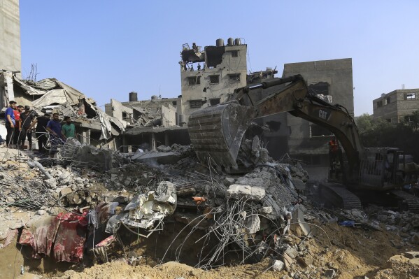 Palestinians inspect the damage of destroyed houses after Israeli airstrikes on Gaza City, Tuesday, Oct. 24, 2023. (AP Photo/Abed Khaled)