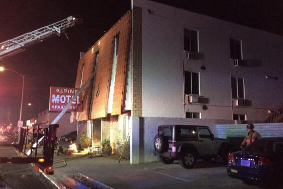 FILE - This photo provided by the Las Vegas Fire Department, firefighters work the scene of a fire at a three-story apartment complex in Las Vegas on Dec. 21, 2019. A Las Vegas rental property inspection program launched in response to the deadliest residential fire in city history has gotten off to a sluggish start, with visits to just two of 36 potentially at-risk complexes, a newspaper found. Approaching the two-year anniversary of the deadly Alpine Motel Apartments fire, which killed six people, the newspaper found the timeline for completing initial inspections was unclear. (Las Vegas Fire Department via AP, File)