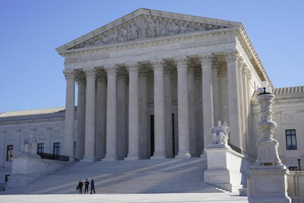 FILE - Visitors walk outside the Supreme Court building on Capitol Hill in Washington, Feb. 21, 2022. (AP Photo/Patrick Semansky, File)