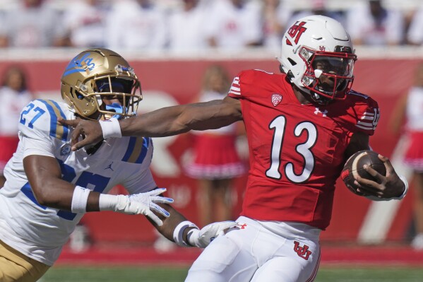 Utah quarterback Nate Johnson (13) is tackled by UCLA defensive back Kamari Ramsey (27) during the first half of an NCAA college football game, Saturday, Sept. 23, 2023, in Salt Lake City. (AP Photo/Rick Bowmer)