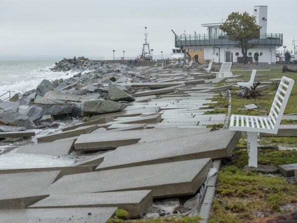 Pavement slabs affected by the storm during the night on the beach promenade in Sassnitz, Germany, Saturday Oct. 21, 2023. A storm continued to batter Britain, northern Germany and southern Scandinavia early Saturday with powerful winds, heavy rain and storm surges that caused floods, power outages, evacuations, traffic disruptions. (Georg Moritz/dpa via AP)