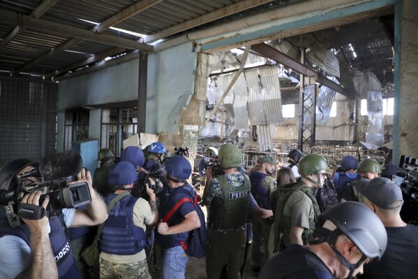 FILE - Journalists visit the destroyed barracks at the Russian-controlled Olenivka prison holding Ukrainian POWs in eastern Ukraine, on Aug. 10, 2022. Russia blamed Ukraine at the time but interviews with survivors witnesses and families of the missing as well as an internal U.N. analysis pointed to Russia as the culprit two years later. (ĢӰԺ Photo/File)