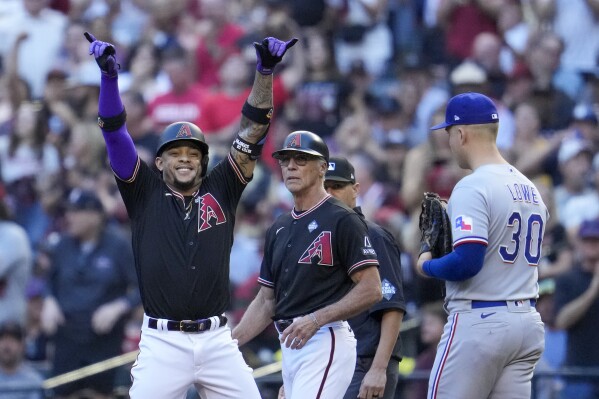 Arizona Diamondbacks' Ketel Marte celebrates a single against the Texas Rangers during the first inning in Game 4 of the baseball World Series Tuesday, Oct. 31, 2023, in Phoenix. (AP Photo/Godofredo A. Vásquez)