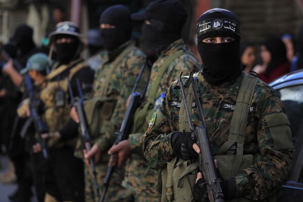 Hamas fighters attend the funeral procession of Samer al-Haj, a Hamas official who was killed by an Israeli drone strike, at Ein el-Hilweh Palestinian refugee camp, in the southern port city of Sidon, Aug. 10, 2024. (AP Photo/Mohammed Zaatari, File)
