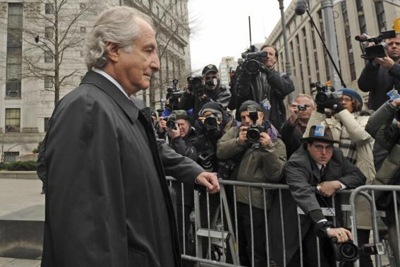 FILE - Bernard Madoff exits Manhattan federal court, Tuesday, March 10, 2009, in New York. The epic Ponzi scheme mastermind  is dead. But the effort to untangle his web of deceit lives on. More than 12 years after Madoff confessed to running the biggest financial fraud in Wall Street history, a team of lawyers is still at work on a sprawling effort to recover money for the thousands of victims of his scam.(AP Photo/ Louis Lanzano, File)